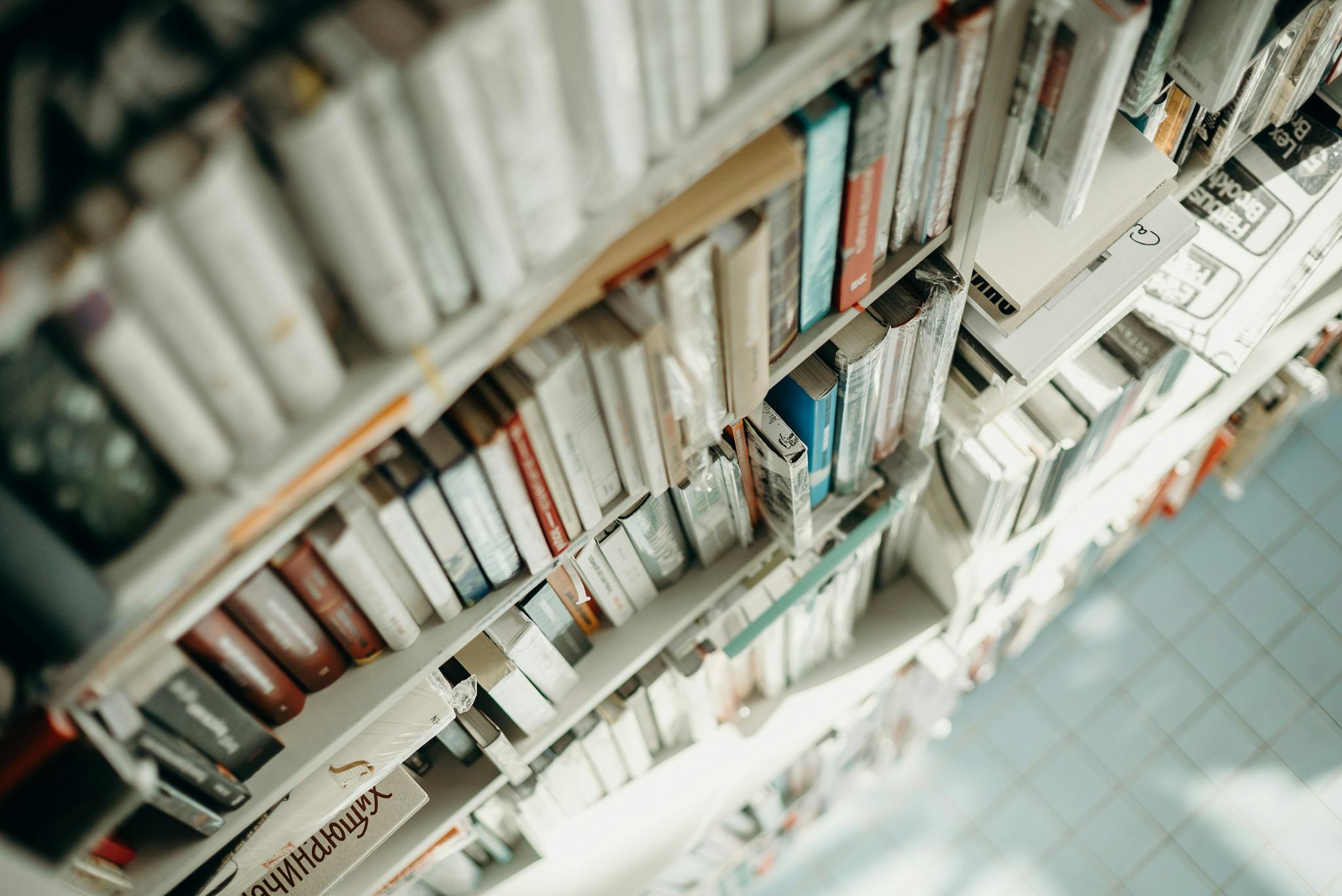 An abstract high angle view of bookshelves in a library with a focus on depth and texture.